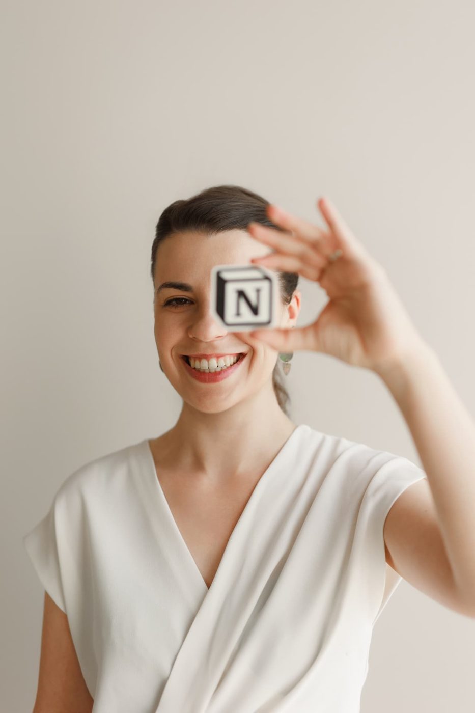 Alexandra Ciuca holding a small Notion logo cube